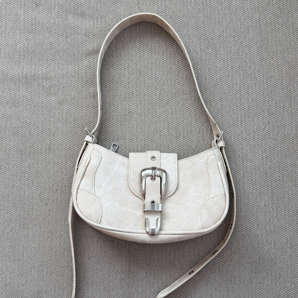 Beige off white shoulder bag with buckle and silver hardware